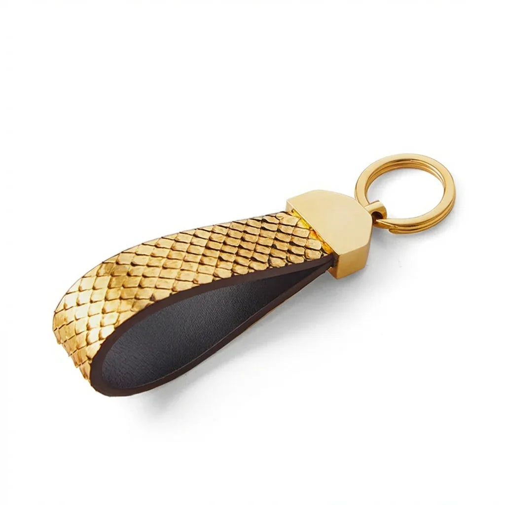 Gold python skin key fob on a white background