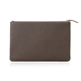 Brown pebbled leather clutch with gold zipper, minimalist design for everyday use