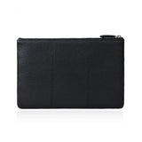 Black pebbled leather clutch with zipper closure, minimalist design for everyday use