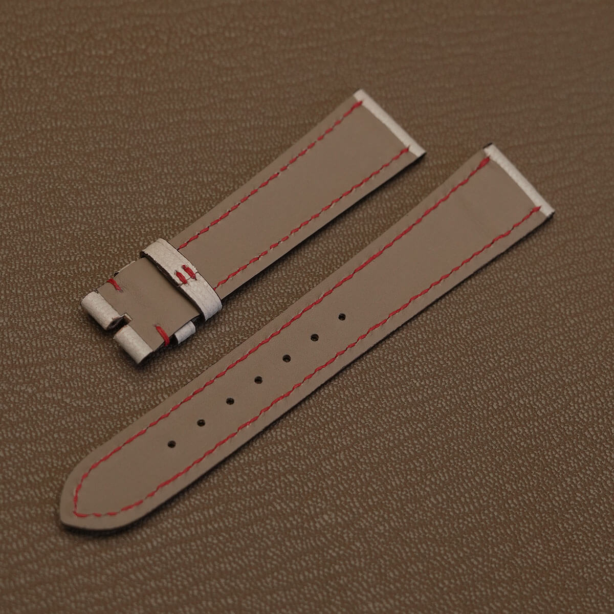 Light grey French Haas Zermatt waterproof lining with red underside stitching on custom watch stra