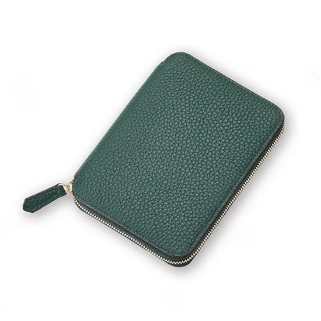 Green pebble leather passport wallet on a white background