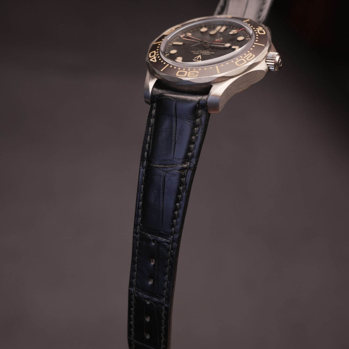Macro detail shot of matte black French HCP alligator leather showing pristine natural symmetrical bamboo scale texture.