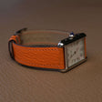 Orange French Alran goat leather strap fitted on stainless steel rectangular luxury watch