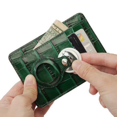 Green wallet with card slots,airtag pocket and money pocket held by a hand on a white background
