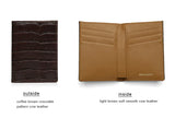 Two wallets, one with coffee brown aligator pattern leather outside and light brown soft smooth cow leather inside, on a white background.