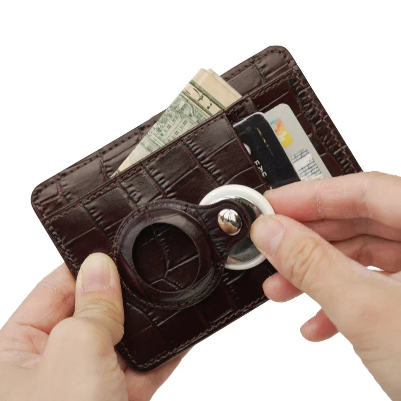 Brown leather card holder and airtag held by hands on a white background