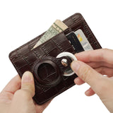 Brown leather card holder and airtag held by hands on a white background