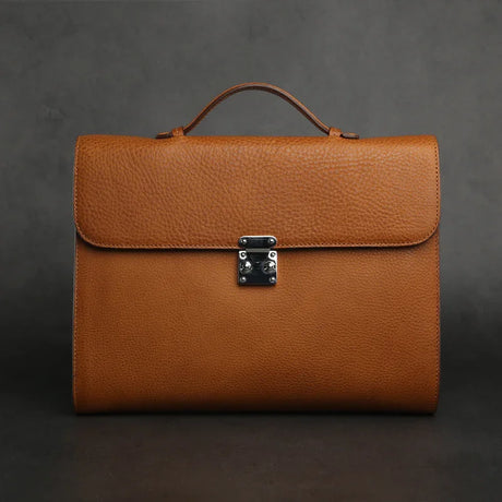 Brown leather tablet briefcases with a silver clasp on a dark background