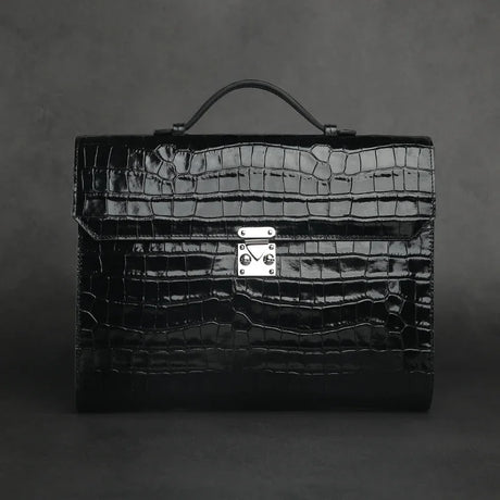 Black crocodile-patterned leather business folios on a dark gray background