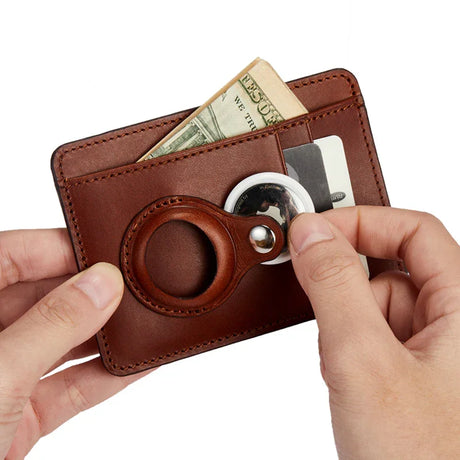 brown vegetable tanned leather airtag wallet and finger is pulling out the airtag