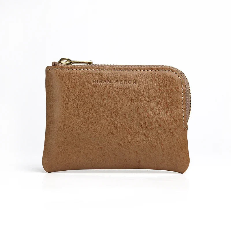 beige leather coin pouch with 'Hiram Beron' branding on a white background