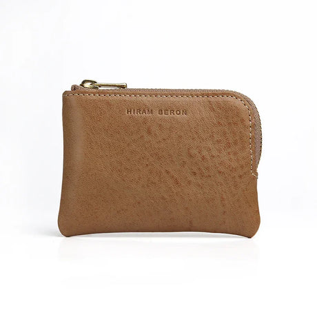 beige leather coin pouch with 'Hiram Beron' branding on a white background