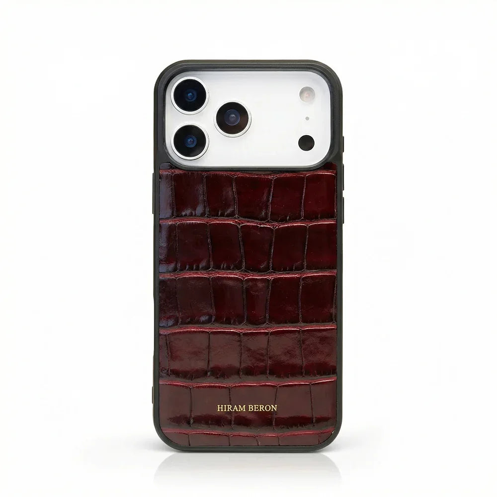 Burgundy crocodile-patterned iphone 17 pro max case with 'Hiram Beron' branding on a white background
