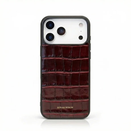 Burgundy crocodile-patterned iphone 17 pro max case with 'Hiram Beron' branding on a white background