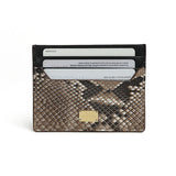 Snake skin card holder with gold accent on a white background