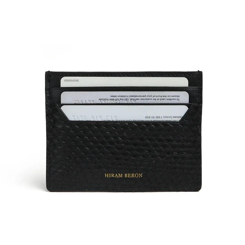 Black python skin cardholder with 'Hiram Beron' branding on a white background