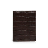 Brown aligator-patterned leather wallet on a white background