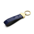 Detail of hand-painted edges on a handcrafted leather key FOB.