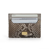 Snake skin card holder with gold accent on a white background