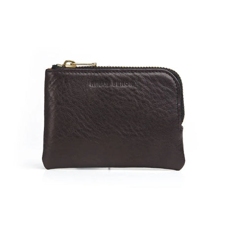 Black leather coin pouch with gold zipper on a white background