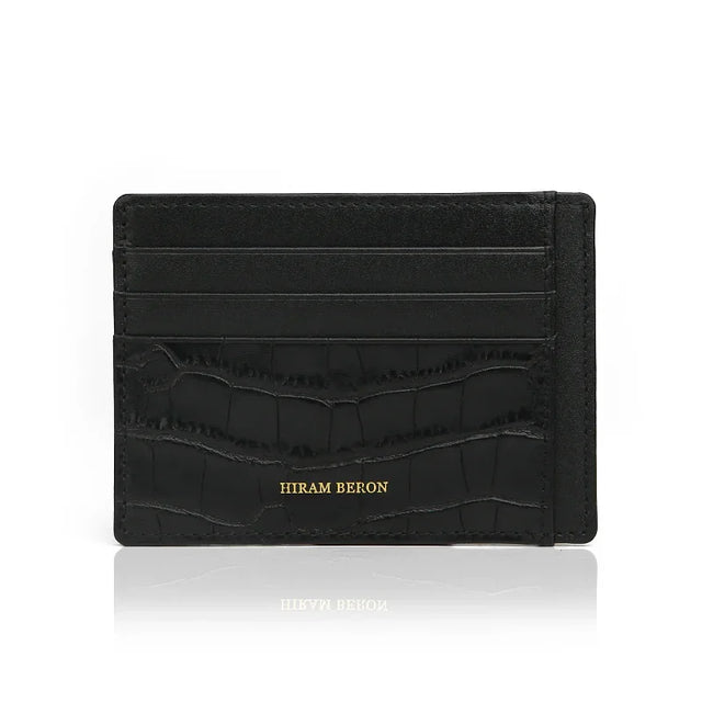 Front view of black embossed crocodile pattern leather card holder with 4 card slots