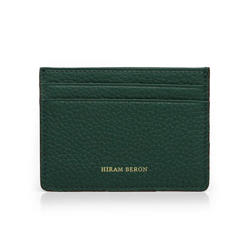 Green pebble leather cardholder with foil stamping 'Hiram Beron' branding on a white background