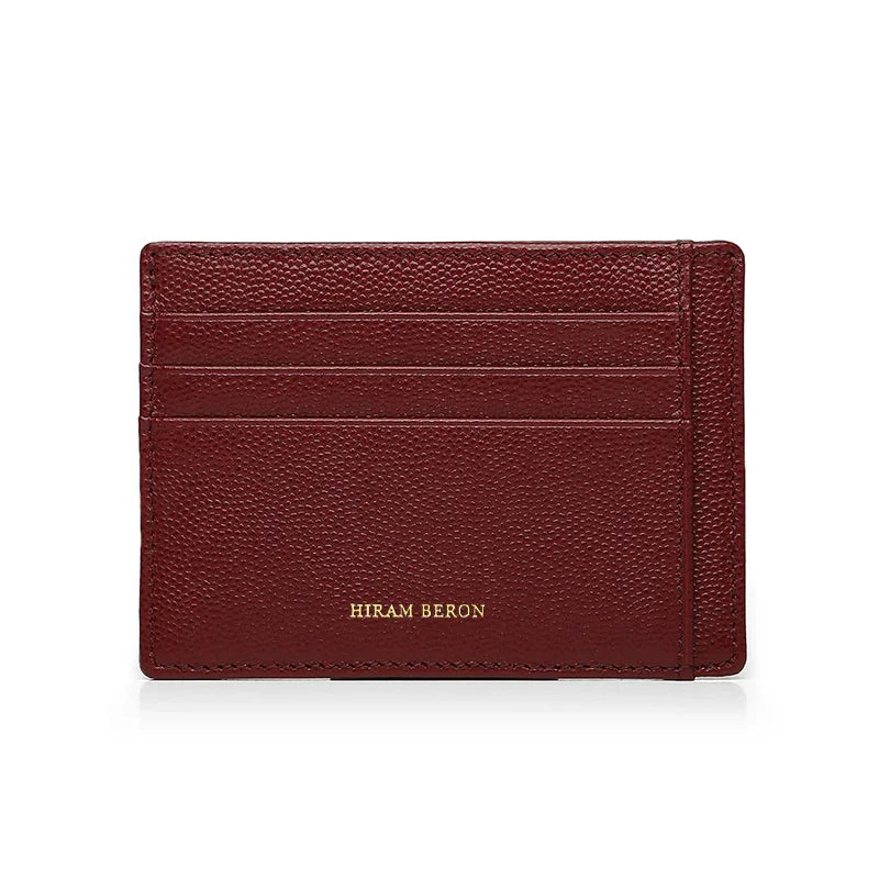 Burgundy leather cardholder with 'Hiram Beron' branding on a white background