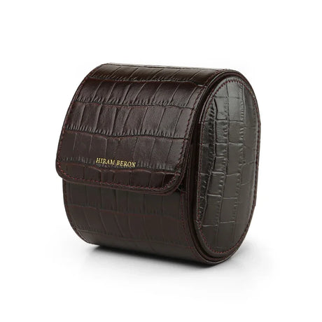 Brown aligator pattern leather watch roll with 'Hiram Beran' branding on a white background