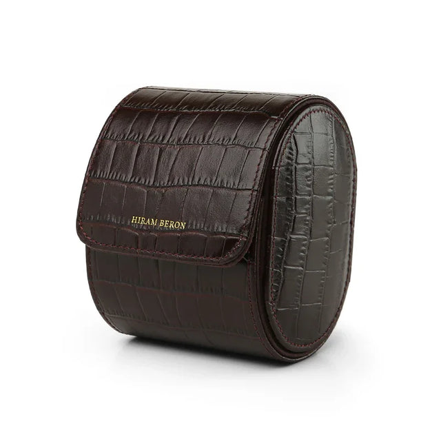 Brown aligator pattern leather watch roll with 'Hiram Beran' branding on a white background