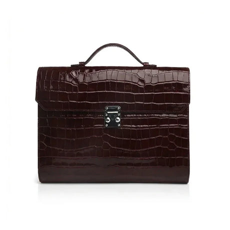 Burgundy crocodile-patterned leather business folios on a white background