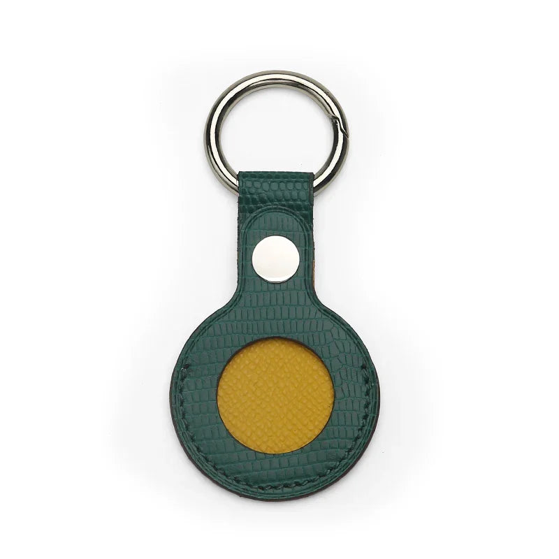 Green leather Airtag keychain with a yellow circle on a white background