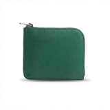 Green vegetable tanned leather coin wallet with a zipper on a white background