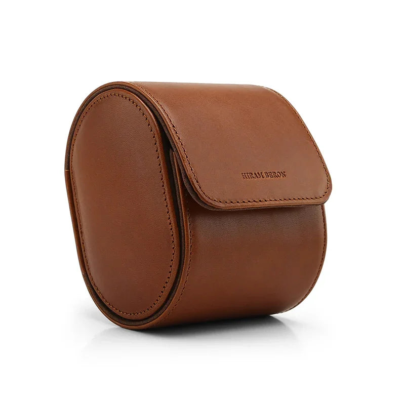 Brown leather watch storage case with brand name on a white background