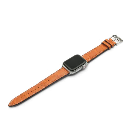 Smartwatch with a orange leather strap on a white background