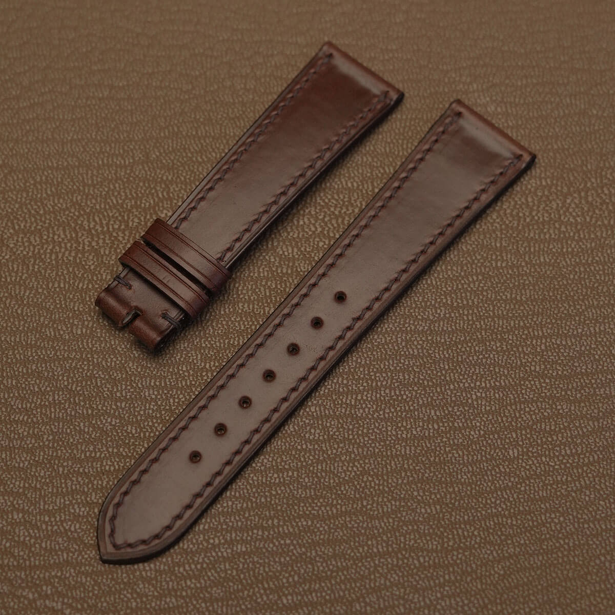 Pair of 1.8mm flat brown Horween Chromexcel leather watch bands showing natural pull-up finish   
JPG