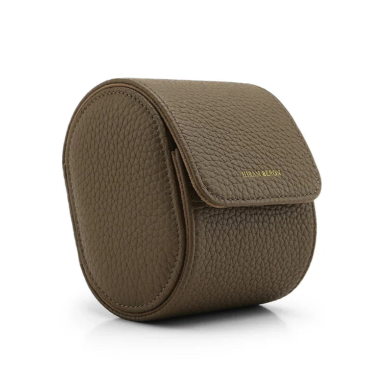 Etoupe round watch travel case with a flap on a white background