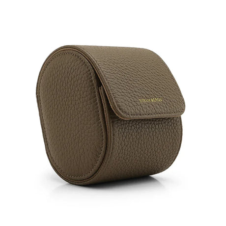 Etoupe round watch travel case with a flap on a white background