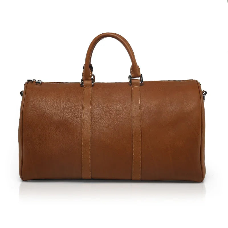 Brown vegetable tanned leather duffel bag on a white background