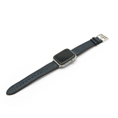 Smartwatch with a dark blue lizard skin watch strap on a white background