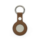 Brown leather airtag cover with a silver ring on a white background