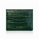 Green crocodile-patterned cardholder with 'Hiram Beron' branding on a white background