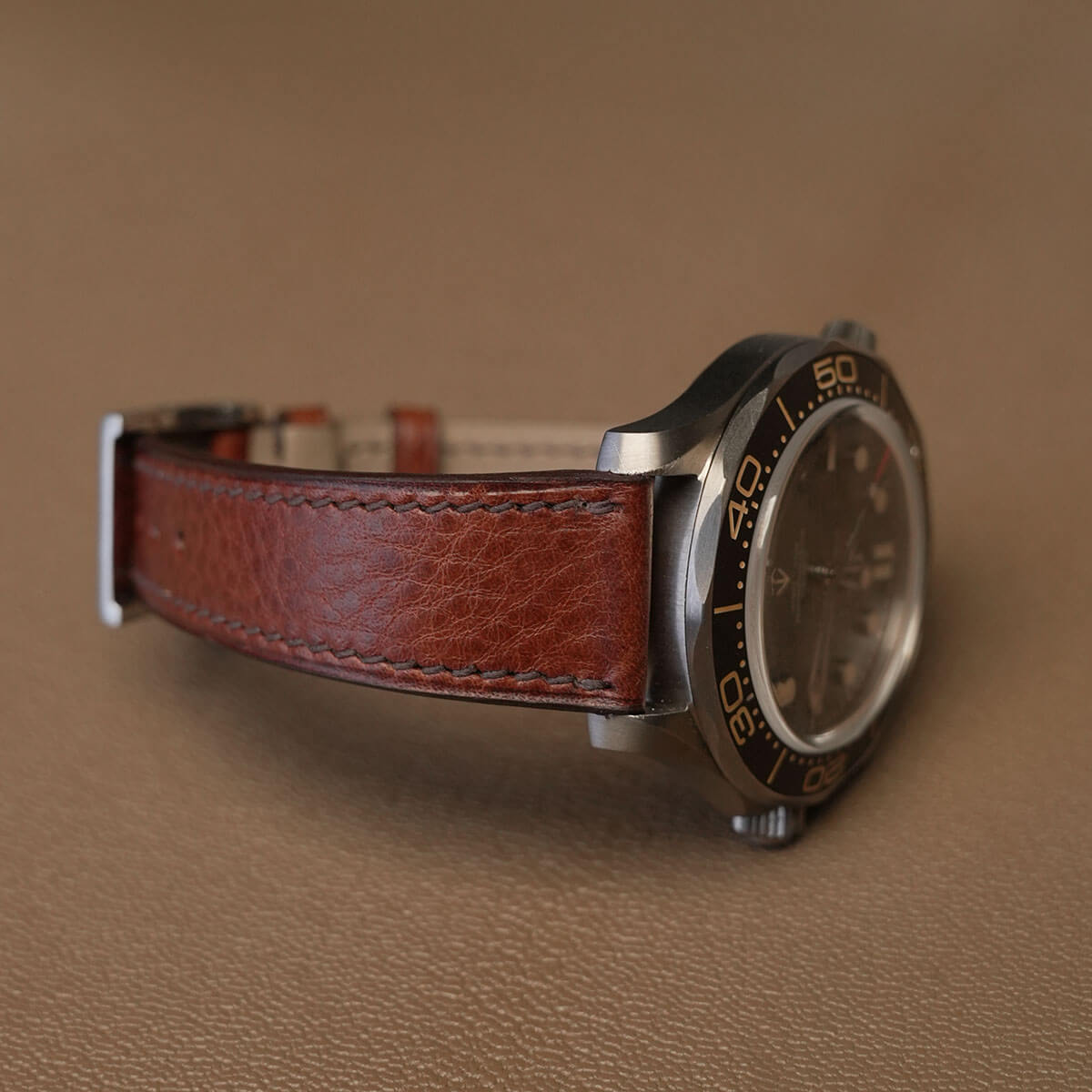 Side profile of 1.8mm slim flat brown Ausonia leather watch strap fitted on sports watch case 