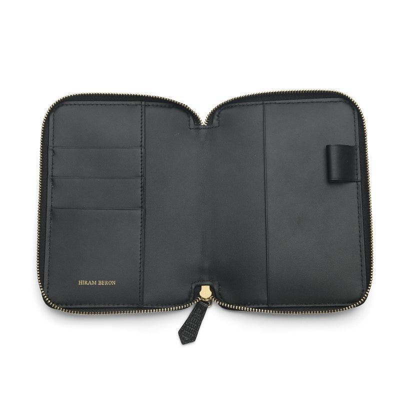 Black leather passport wallet with zipper on a white background