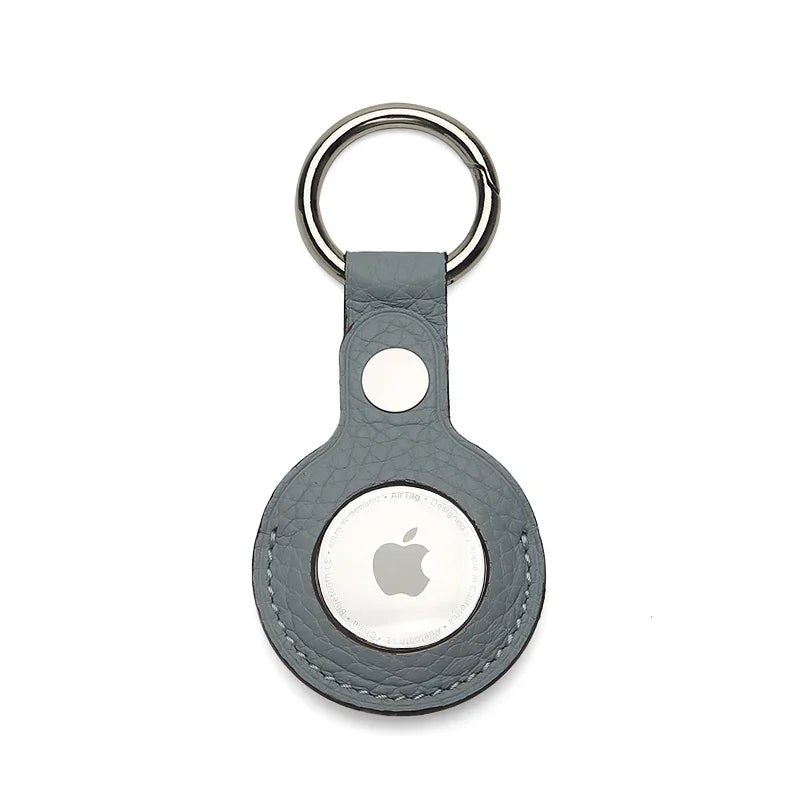 Apple AirTag holder in a gray leather case on a white background