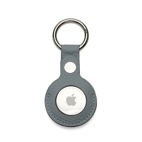 Apple AirTag holder in a gray leather case on a white background