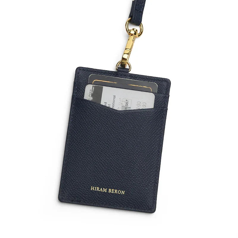navy cardholder with gold accent and 'Hiram Beron' branding on a white background
