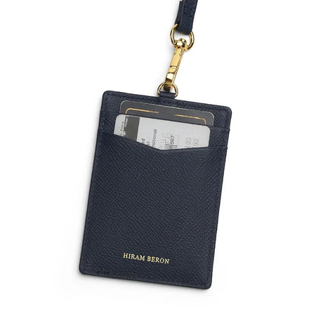 navy cardholder with gold accent and 'Hiram Beron' branding on a white background