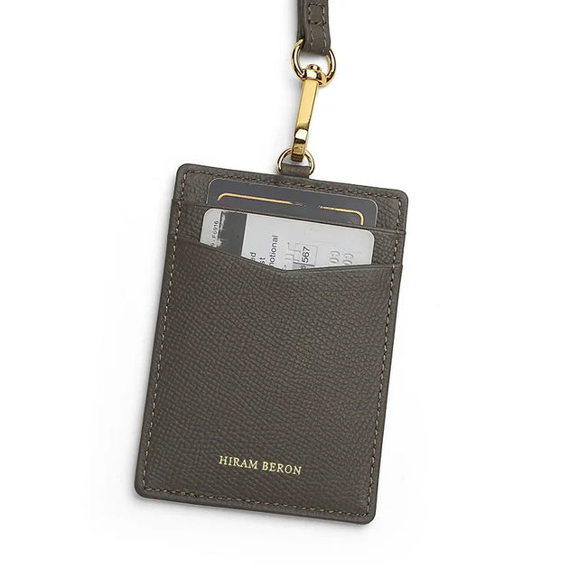 Gray leather card holder with a lanyard on a white background