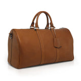 Brown vegetable tanned leather weekender bag on a white background
