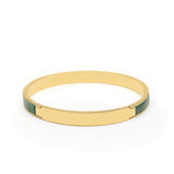 Gold bangle bracelet with green stone inlay, minimalist luxury accessory